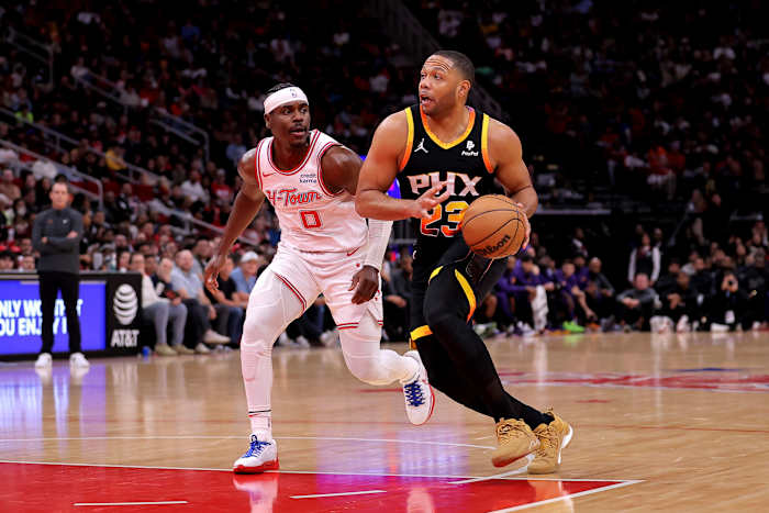 Dec 27, 2023; Houston, Texas, USA; Phoenix Suns guard Eric Gordon (23) drives to the basket against Houston Rockets guard Aaron Holiday (0) during the game at Toyota Center.